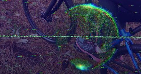 Glitch-distorted blue bicycle crank and gray pink sneaker on pine needles with digital noise overlay