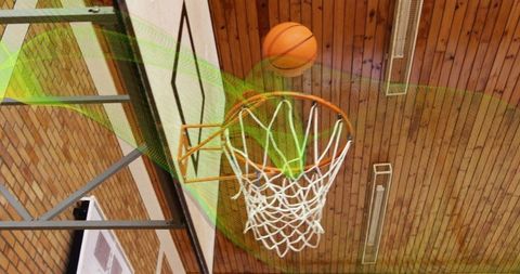 Basketball Swish Through Hoop in Dramatic Indoor Gymnasium