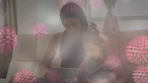 Mother and Daughter Using Tablet with COVID-19 Virus Overlay