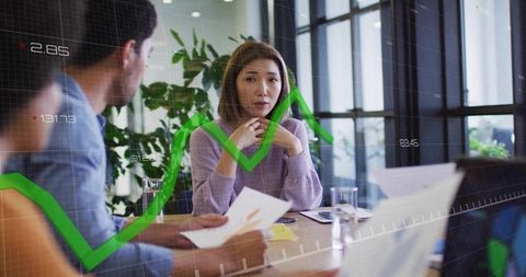 Concerned woman listening during business meeting with green financial trend line overlay
