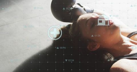 Sweaty woman resting after intense kettlebell workout with fitness hud data