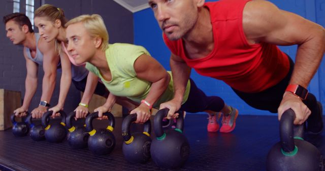 Group Fitness Class Doing Push-Ups with Kettlebells - Download Free Stock Images Pikwizard.com