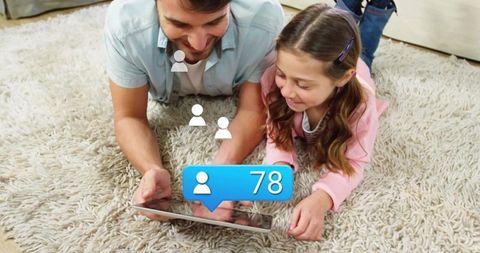 Father and Daughter Viewing Tablet Receiving Social Notifications