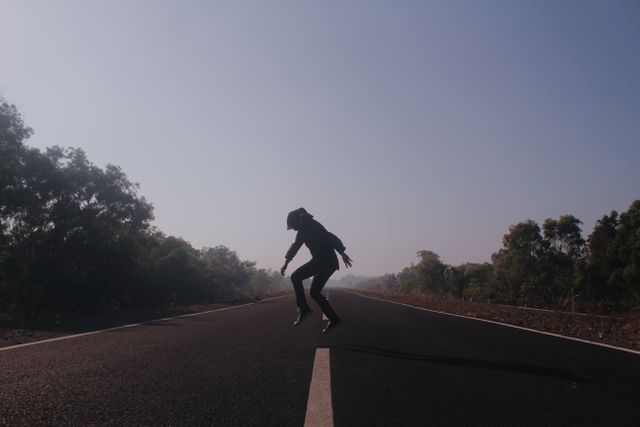 Person Jumping on Empty Road at Sunrise - Download Free Stock Photos Pikwizard.com