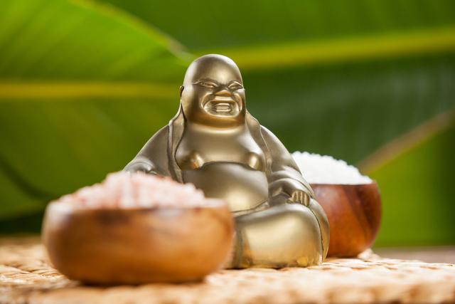 Laughing Buddha Figurine with Sea Salt in Wooden Bowls on Mat - Download Free Stock Photos Pikwizard.com