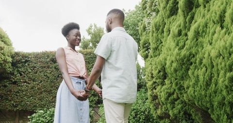 Joyful Engagement Proposal in Lush Garden Setting