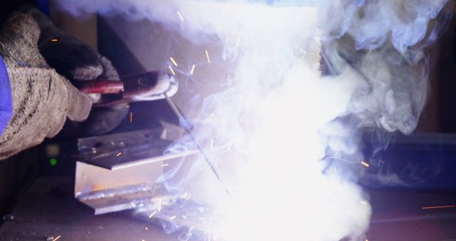 Close-Up of Industrial Welding Process with Bright Sparks and Smoke - Download Free Stock Images Pikwizard.com