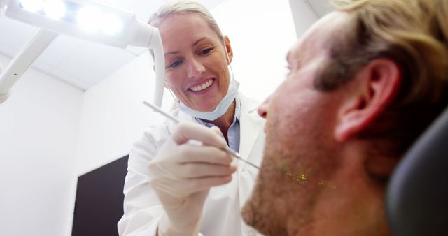 Friendly Dentist Examining Patient in Modern Clinic - Download Free Stock Images Pikwizard.com