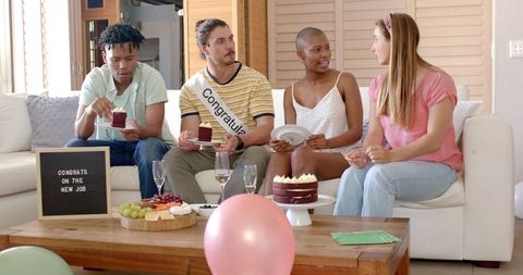Group Celebrating New Job with Cake and Snacks