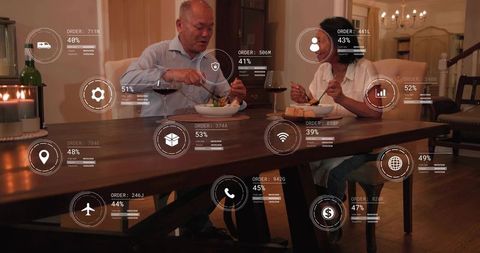 Senior couple enjoying candlelit dinner with smart hud overlays on wooden dining table