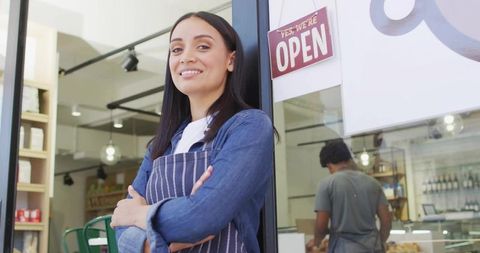 Confident Entrepreneur Greeting Customers at Cafe Entrance