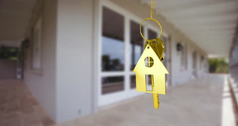 Golden Key with House Icon Symbolizing Home Ownership