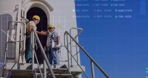 Engineers Analyzing Wind Turbine with Financial Data Overlay