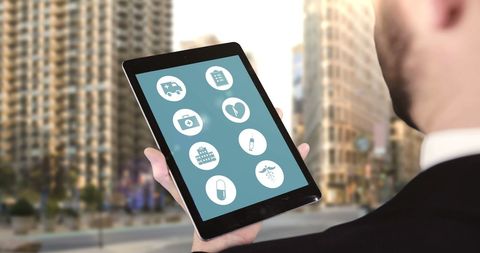 Businessman Exploring Health Apps on Tablet in Urban Setting