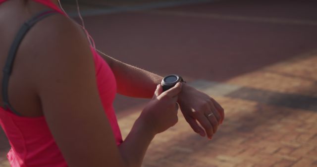 Woman Checking Fitness Tracker During Outdoor Run - Download Free Stock Images Pikwizard.com