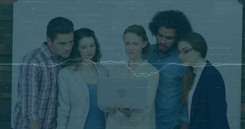 Startup team gathering around laptop with audio waveform overlay planning strategy