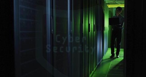 Technician configuring server racks in led lit corridor