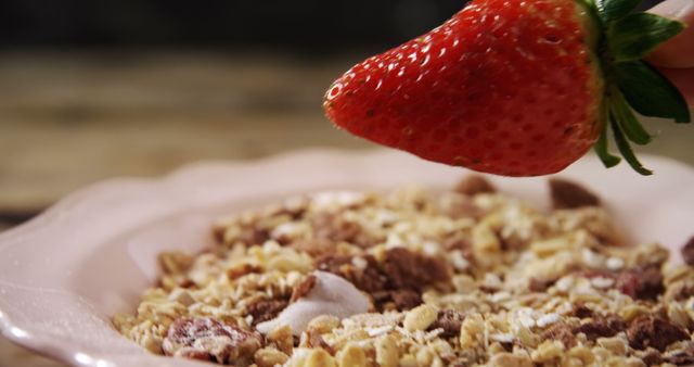 Close-up of strawberry kept in breakfast cereal 