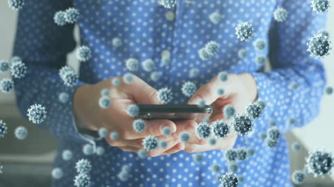 Person Holding Smartphone with Floating COVID-19 Virus Particles