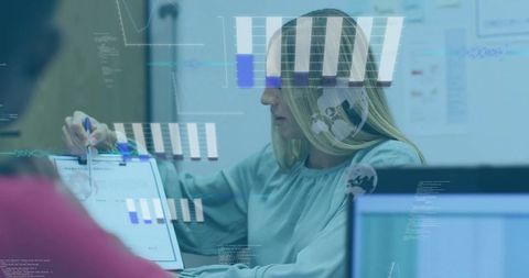 Businesswoman presenting data with interactive hud overlays in boardroom team meeting