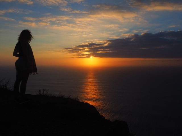 Silhouette of Woman Watching Sunset Over Ocean - Download Free Stock Photos Pikwizard.com