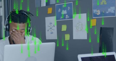 Stressed african american businessman with digital data overload