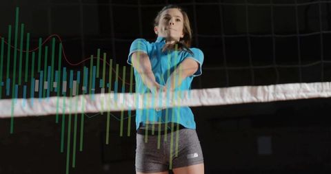 Female volleyball player jumping and bumping at indoor net with analytics data overlay