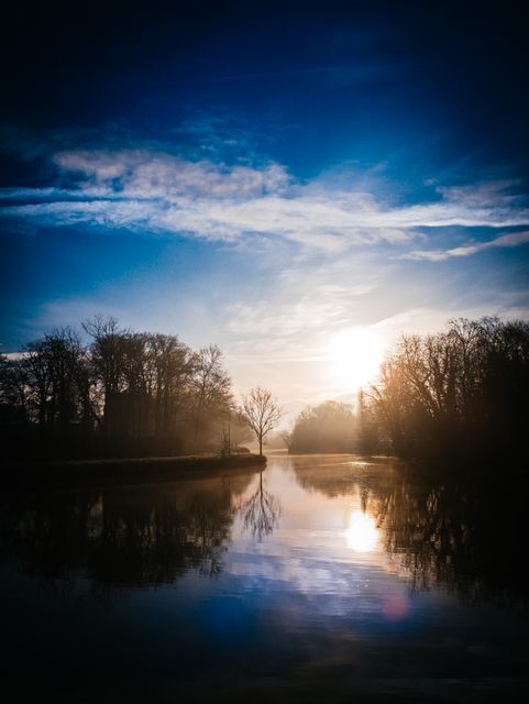 Serene Sunrise Over Calm River with Tree Reflection on Water - Download Free Stock Photos Pikwizard.com