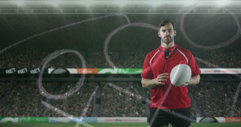 Professional rugby player on stadium field holding ball