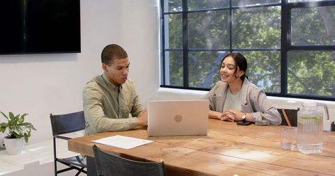 Business Colleagues Discussing Project in Modern Office Meeting Room