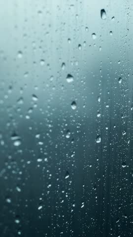 Raindrops Sliding Down Car Window Merging into Streaks with Blurred Shapes Vertical Video