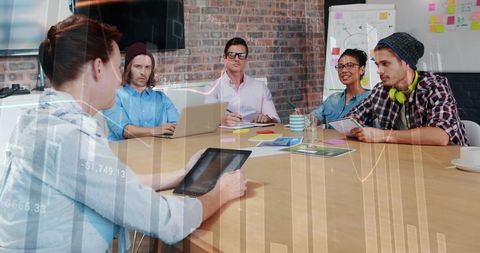 Diverse Team Meeting with Financial Data Processing Overlay