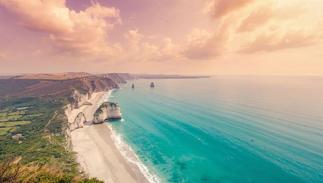 Sunset Light Bathing White Chalk Cliffs and Turquoise Sea with Sandy Beach and Sea Stacks