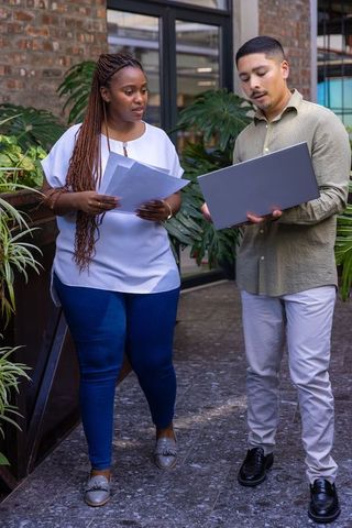 Diverse professionals collaborating in modern office atrium