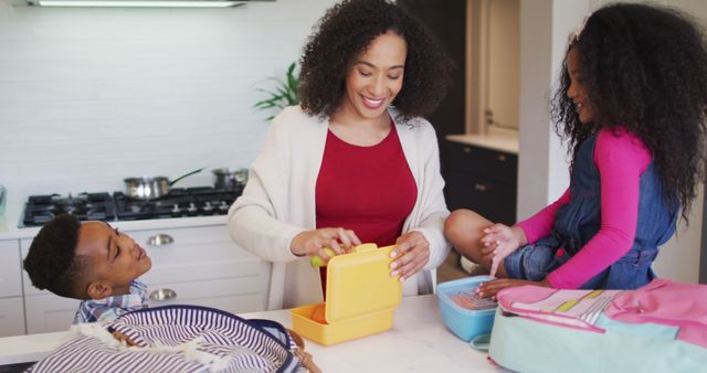 Happy Mother Packing Lunches with Kids in Kitchen - Download Free Stock Images Pikwizard.com