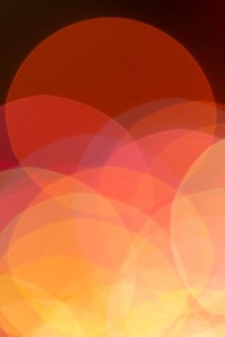 Warm Bokeh Circles Creating Festive Orange and Red Light Blur Background for Design