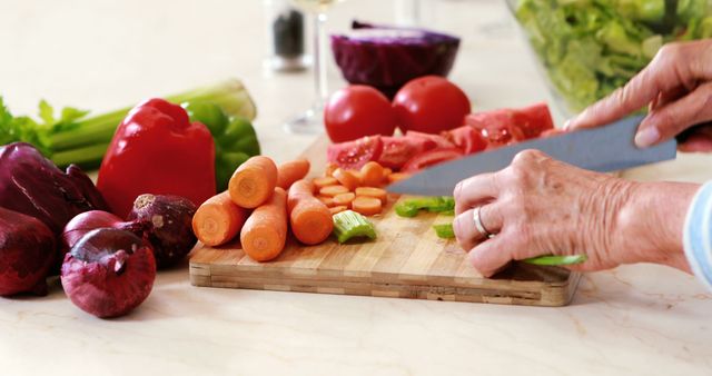 Close-Up of Person Chopping Fresh Vegetables on Wooden Cutting Board in Kitchen - Download Free Stock Images Pikwizard.com