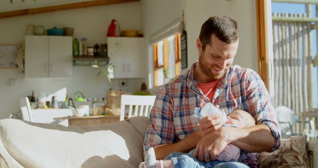 Caring Father Feeding Baby in Bright Living Room - Download Free Stock Images Pikwizard.com