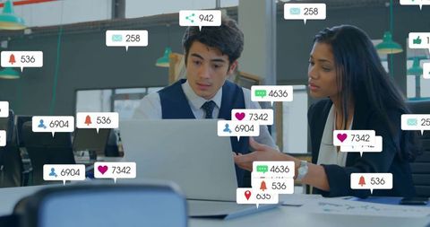Business Team Analyzing Performance Data on Laptop in Modern Office