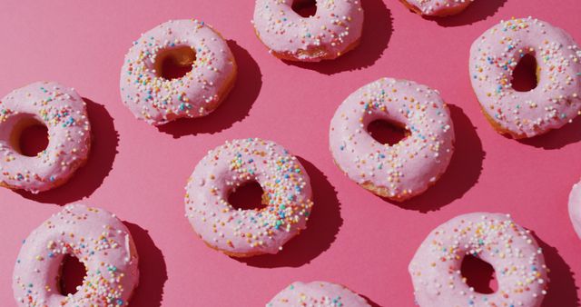 Image of donuts with icing on pink background. colourful fun food, candy, snacks and sweets concept.