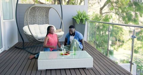 Couple Enjoys VR Headset on Sunny Outdoor Patio