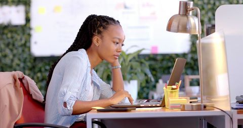 Focused Businesswoman Using Laptop in Contemporary Office - Download Free Stock Images Pikwizard.com