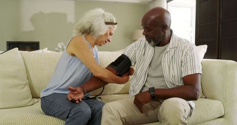 Diverse Couple Checking Blood Pressure at Home