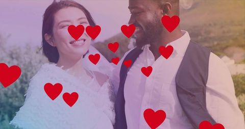 Smiling bride leaning toward groom on sunlit hillside with red heart overlays
