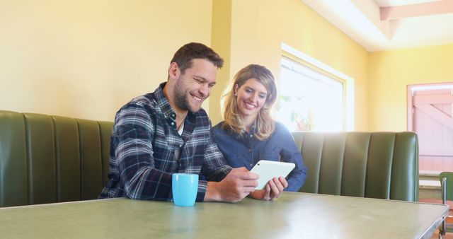 Couple Using Digital Tablet in Retro Diner Booth - Download Free Stock Images Pikwizard.com