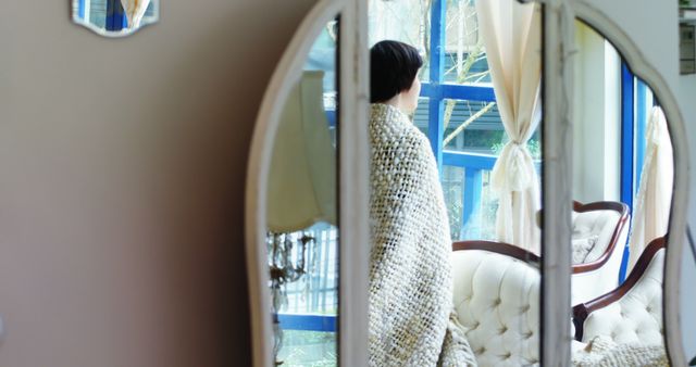 Reflective Woman Standing by Window in Cozy Blanket - Download Free Stock Images Pikwizard.com