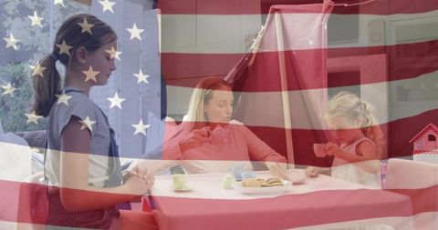 Caregiver pouring tea for daughters during indoor tea party with American flag overlay