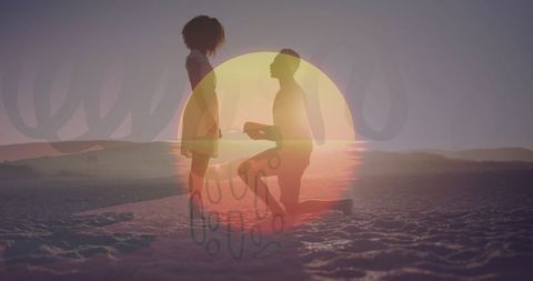 Sunset proposal on beach showing silhouetted romantic moment