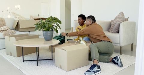 Energetic Couple Unpacking in Cozy Living Room
