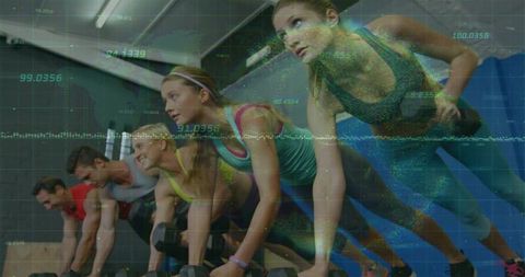 Holding plank with dumbbells and digital data overlay, group training in gym